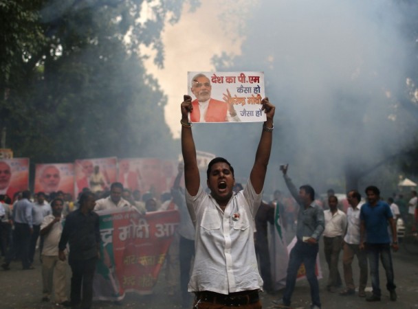 A supporter of BJP celebrates before Narendra Modi was crowned as prime ministerial candidate for the party in New Delhi BJP supporter