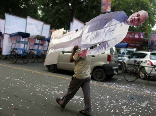 A BJP supporter carries a cutout of Narendra Modi before he was crowned prime ministerial candidate for the party in New Delhi BJP supporter