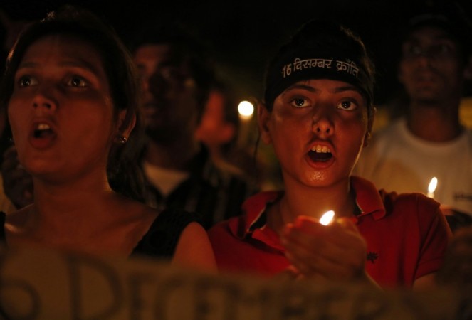 Demonstrators shout slogans as they hold candles during a candle light vigil Demonstrators shout slogans as they hold candles during a candle light vigil