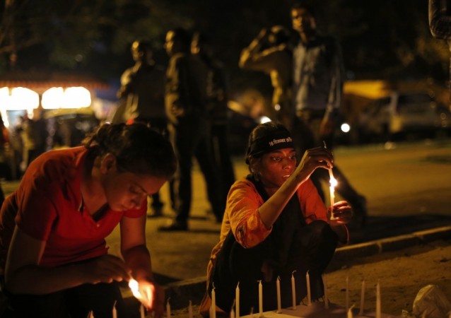 Demonstrators light candles during a candle light vigil after four men convicted of raping and murdering a 23-year-old woman in Delhi were sentenced to death in New Delhi Delhi Gang-rape case