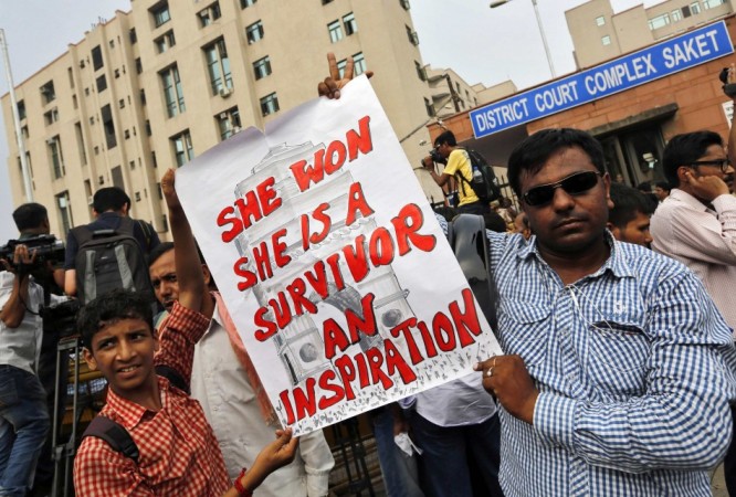 Demonstrators hold a placard outside a court in New Delhi Delhi gang-rape case