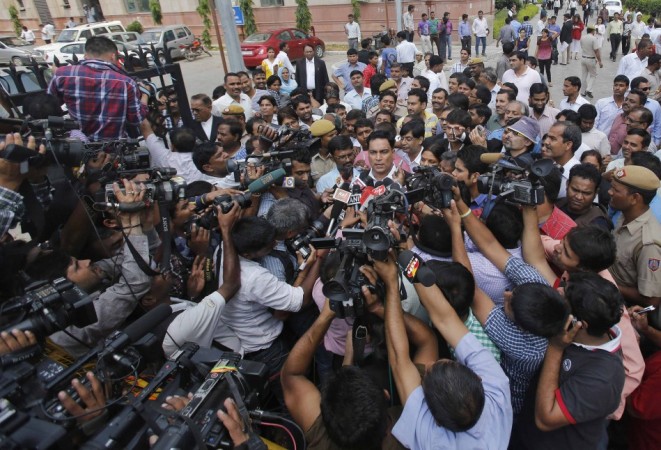 A.P. Singh, defence lawyer for one of the four men who were found guilty of the fatal gang-rape of a young woman on a bus in New Delhi, speaks with the media after the verdict in New Delhi Delhi gang-rape case