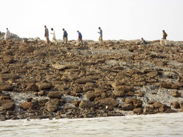 People walk on an island that rose from the sea following an earthquake, off Pakistan's Gwadar coastline in the Arabian Sea. People walk on an island that rose from the sea following an earthquake, off Pakistan's Gwadar coastline in the Arabian Sea.