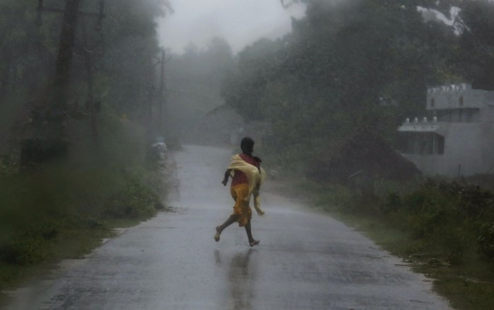 A girl runs for shelter in heavy rain brought by Cyclone Phailin in Ichapuram (Representational Image) Cyclone Phailin