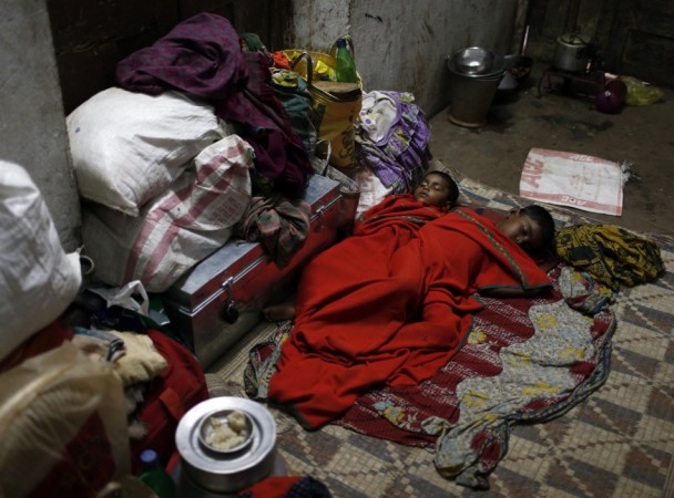 Boys sleep on the floor of a wedding hall after leaving their house to take shelter from the impact of the approaching Cyclone Phailin, in the eastern Indian state of Odisha Cyclone Phailin