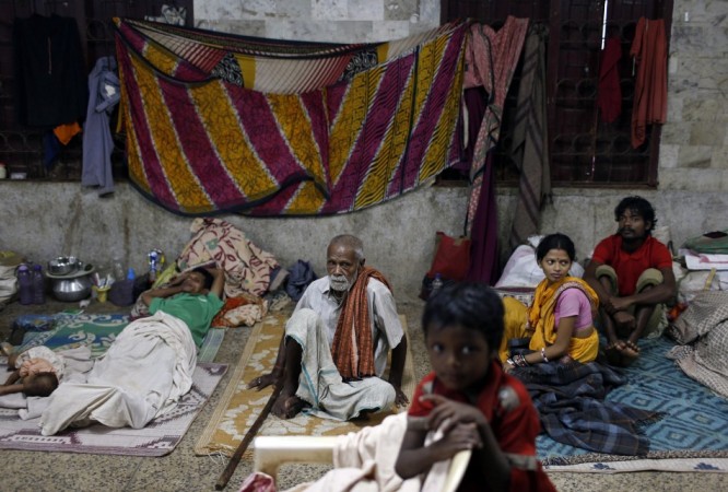 People take shelter at a wedding hall after leaving their houses to take shelter from the impact of the approaching Cyclone Phailin, in the eastern Indian state of Odisha Cyclone Phailin
