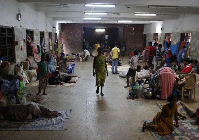 People take shelter at a wedding hall after leaving their houses to take shelter from the impact of the approaching Cyclone Phailin, in the eastern Indian state of Odisha Cyclone Phailin