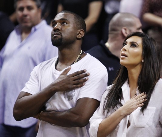 Rap musician Kanye West is seen court side with reality television star Kim Kardashian during the national anthem before the Miami Heat played the New York Knicks in their NBA basketball game in Miami, Florida December 6, 2012. Kim Kardashian, kanye West