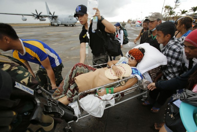 An injured woman prepares to be airlifted at Tacloban airport in the aftermath of super typhoon Haiyan Typhoon Haiyan