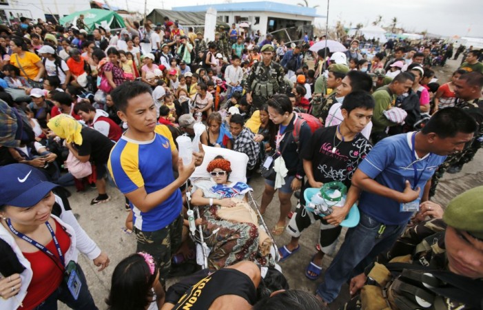An injured woman waits to be transported to Manila in the aftermath of typhoon Haiyan in Tacloban Typhoon Haiyan