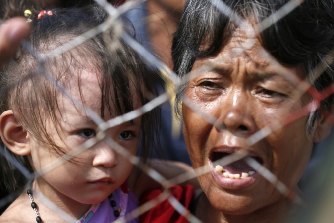 A woman waits to be airlifted to Manila at Tacloban airport in the aftermath of super typhoon Haiyan Typhoon Haiyan