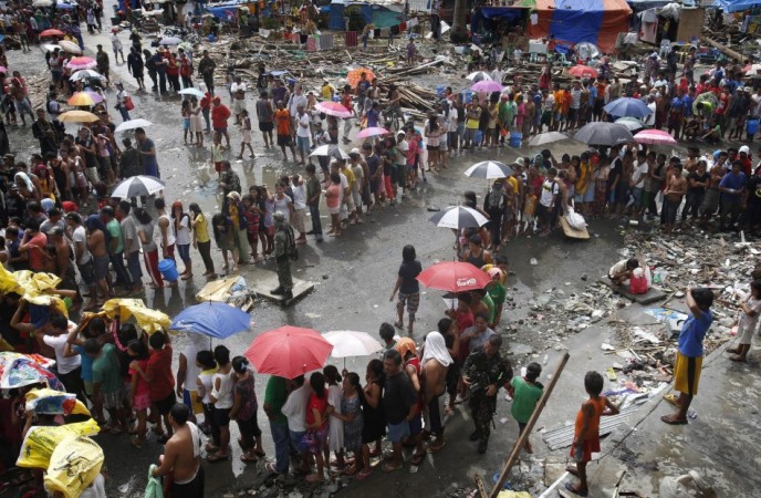Victims queue for food and water in the aftermath of super typhoon Haiyan in Tacloban Typhoon Haiyan