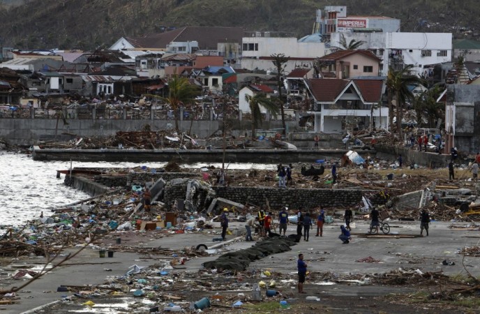 A row of body bags are laid out on the beach after super typhoon Haiyan battered Tacloban Typhoon Haiyan