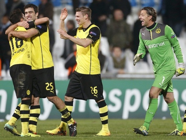 Borussia Dortmund players celebrate their victory over Marseille, December 11. Reuters Borussia Dortmund Piszczek Weidenfeller Sahin Sokratis