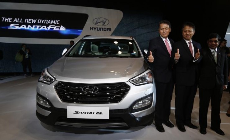 Senior executives of Hyundai Motors India Limited (HMIL) pose with Hyundai's Santa Fe car during its launch at the Auto Expo in Greater Noida on the outskirts of New Delhi on February 5, 2014.