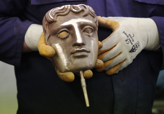 A fettler holds a British Academy of Film and Television Arts award before it is sent away for polishing BAFTA Awards 2014