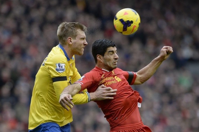 Arsenal defender Per Mertesacker and Liverpool forward Luis Suarez look to head the ball during their English Premier League game, 8 February. Reuters Suarez Liverpool Mertesacker Arsenal