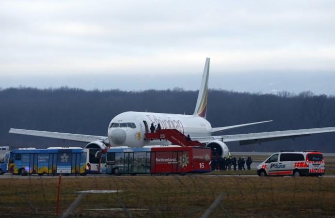 Police officers stand around hijacked Ethiopian Airlines flight ET 702 at Cointrin airport in Geneva