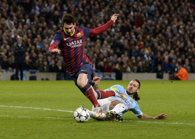 Barcelona forward Lionel Messi is brought down by Manchester City defender Martin Demichelis in their Champions League game, 18 February. Reuters Lionel Messi Barcelona Martin Demichelis Machester City