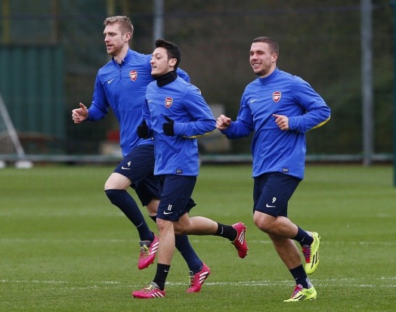 Arsenal's German players Per Mertesacker, Mesut Ozil and Lukas Podolski during a training session in London Colney ahead of their Champions League clash against Bayern Munich, 18 February. Reuters Mertesacker Ozil Podolski Arsenal