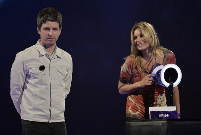 Model Kate Moss accepts the British Male Solo Artist award on behalf of David Bowie as Noel Gallagher looks on at the BRIT Awards in London Noel Gallagher, Kate Moss