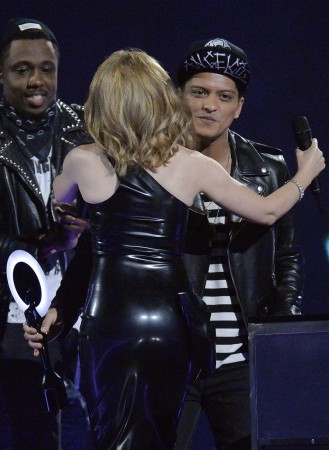 Singer Minogue congratulates Bruno Mars after he won the International Male Solo Artist award at the BRIT Awards, celebrating British pop music, at the O2 Arena in London Bruno Mars