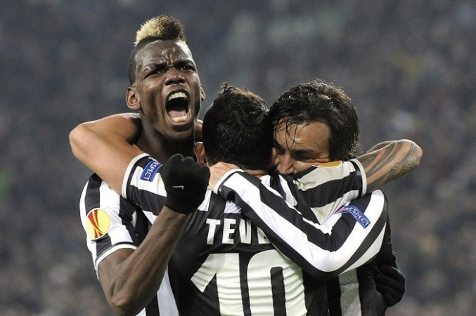 Juventus midfielder Paul Pogba celebrates with teammates Carlos Tevez and Andrea Pirlo after scoring against Trabzonspor in the Europa League, 20 February. Reuters Paul Pogba Pirlo Tevez Juventus