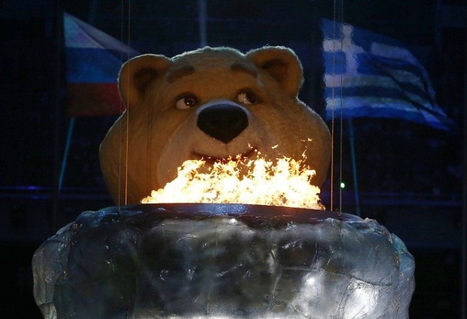 An Olympic Games mascot pauses before extinguishing the Olympic flame in a small cauldron in the stadium during the closing ceremony for the Sochi 2014 Winter Olympics, February 23. Reuters. Sochi 2014