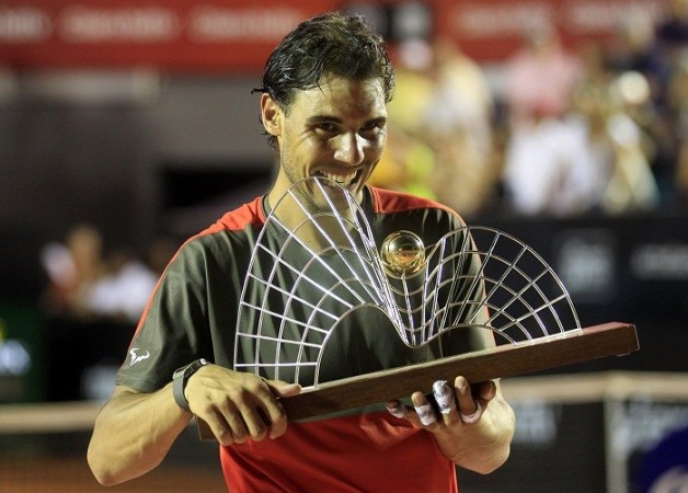 Rafael Nadal of Spain bites his trophy after winning against Alexandr Dolgopolov of Ukraine at the 2014 Rio Open men's final tennis match in Rio de Janeiro, February 23. Reuters. Rio Open Finals