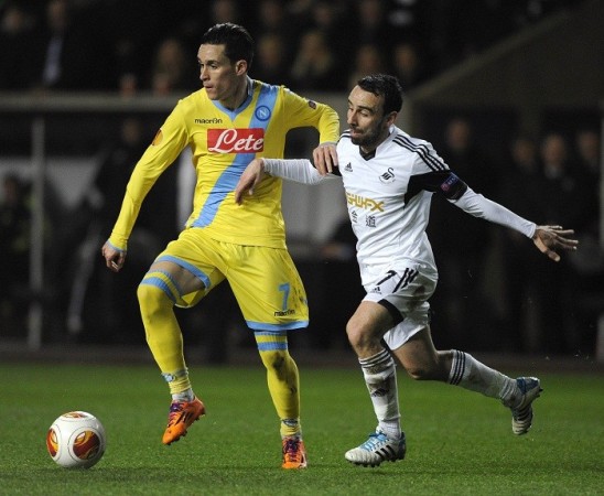 Swansea midfielder Leon Britton challenges Napoli forward Jose Callejon for the ball during their Europa League first leg game, 20 February. Reuters Callejon Napoli Britton Swansea