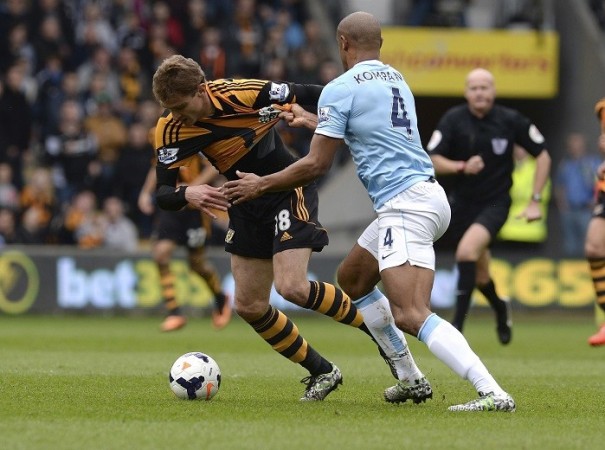 Manchester City skipper Vincent Kompany brings down Hull City striker Nikica Jelavic in their English Premier League game, 15 March. Reuters Kompany Manchester City Jelavic Hull City