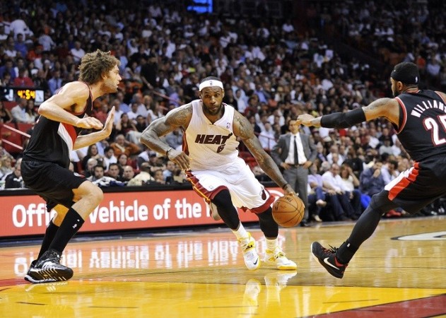 Miami Heat forward LeBron James drives to the basket in the NBA game against the Portland Trail Blazers, 24 March. Reuters LeBron James Miami Heat Portland Trail Blazers