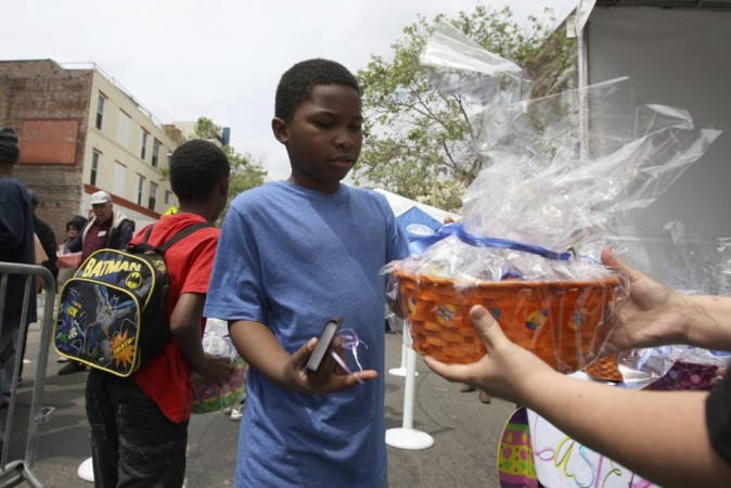 Easter 2014: A boy receives an Easter basket at a Good Friday Easter event sponsored by the Los Angeles Mission to help the homeless and near-homeless of Skid Row in Los Angeles, California. (Photo: Reuters)