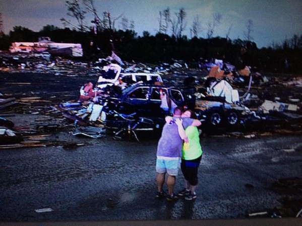 Lori Berseth is consoled after searching for her missing black labrador dog Lucille after a tornado destroyed the town of Mayflower (Photo: Reuters)