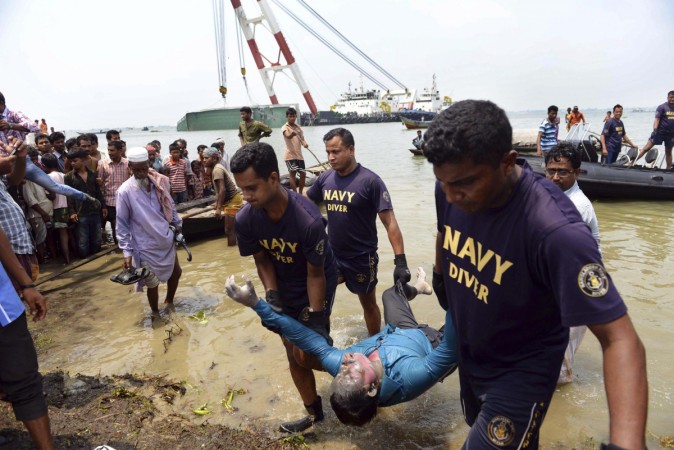 Members of the Bangladesh Navy recover the body of a passenger from the capsized M.V. Miraj 4 ferry by the Meghna river at Rasulpur in Munshiganj district