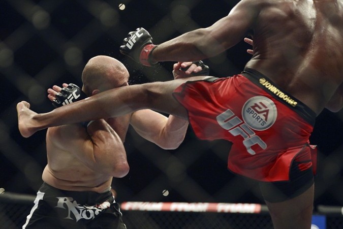 Jon Jones kicks Glover Teixeira in the head during the UFC light heavy weight championship fight. UFC Jon Jones Glover Teixeira