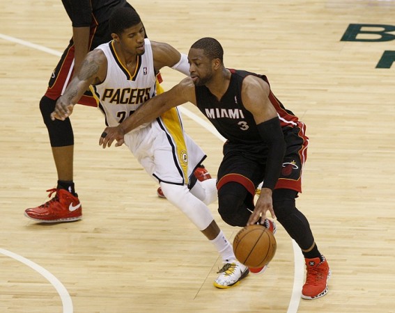 Miami Heat's Dwyane Wade dribbles around Indiana Pacers' Paul George. Dwyane Wade Miami Heat