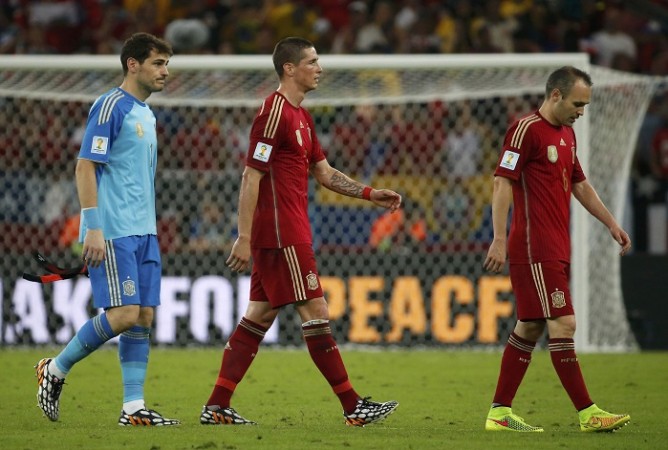 Iker Casillas, Fernando Torres and Andres Iniesta walk off the field dejected after their loss to Chile, 18 June Casillas Torres Iniesta Spain