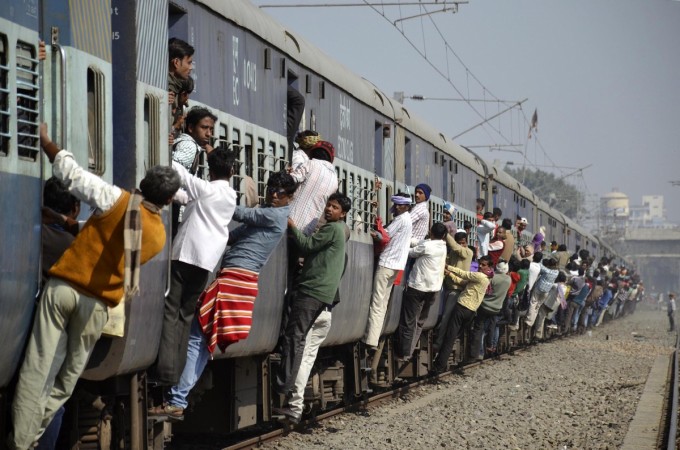Commuters hang onto a crowded local passenger train in the eastern Indian city of Patna (Reuters file)
