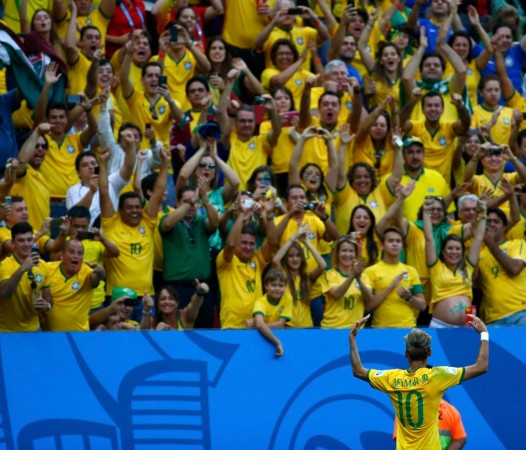 Brazil forward Neymar celebrates with the supporters after scoring against Cameroon, 23 June Neymar Brazil crowd