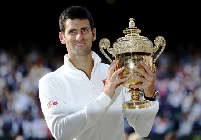 Novak Djokovic holds the winners trophy after defeating Roger Federer. Novak Djokovic Wimbledon Title