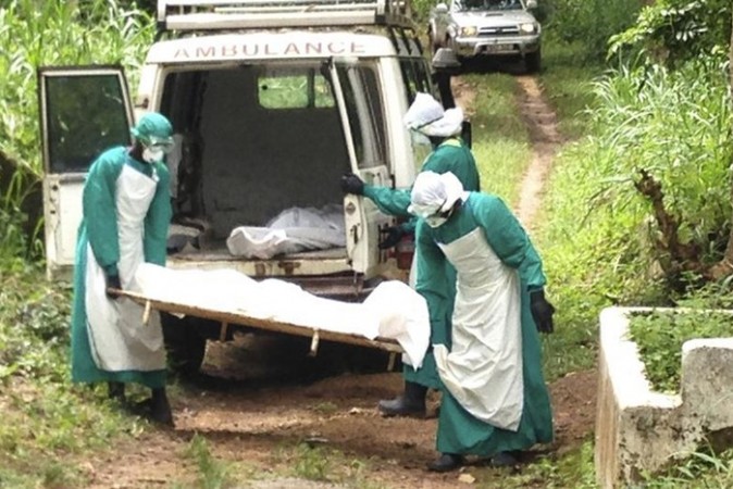Health workers carry the body of an Ebola virus victim in Kenema