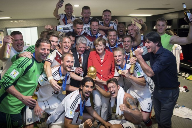 German Chancellor Merkel and German President Gauck pose with the Germany's coach Loew and his players after Germany beat Argentina in the 2014 World Cup final at the Maracana stadium in Rio de Janeiro Germany