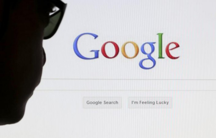 A computer user poses in front of a Google search page in this photo illustration taken in Brussels on May 30, 2014. Google Plus