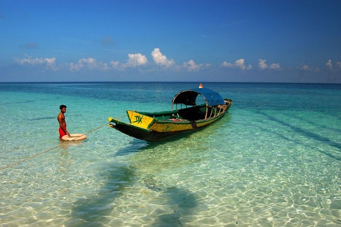 Person with a boat in Elephant beach, Havelock Island in Andaman Andamans, new railways coming up
