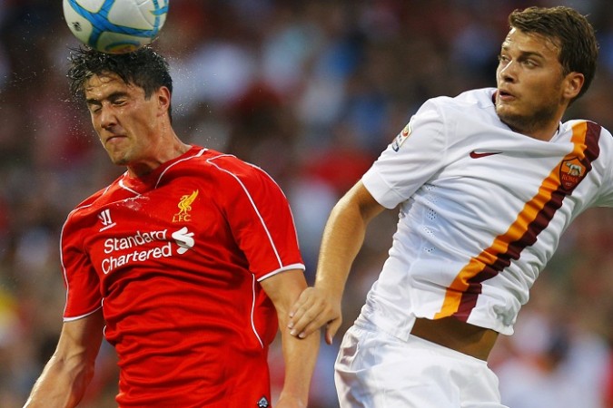 Liverpool's Martin Kelly heads the ball in front of AS Roma's Adem Ljajic in a preseason friendly. Martin Kelly and Adem Ljajic