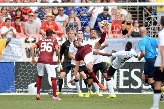 Roma defender Leandro Castan attempts an overhead kick as United midfielder Jesse Lingard defends. Leandro Castan