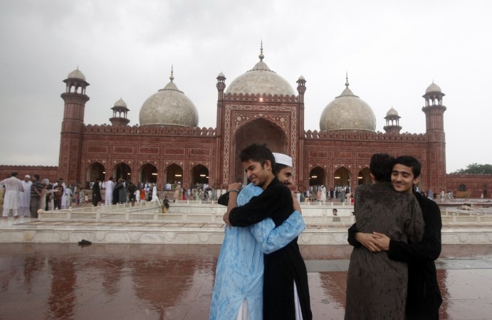 Pakistani Muslims congratulate each other after saying their Eid al Fitr prayers at the Badshahi mosque in Lahore July 29, 2014. Eid al-Fitr