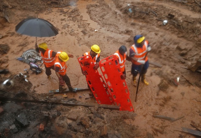 National Disaster Response Force (NDRF) personnel carry stretchers at the site of a landslide at Malin village in the western Indian state of Maharashtra July 31, 2014. Pune Landslide