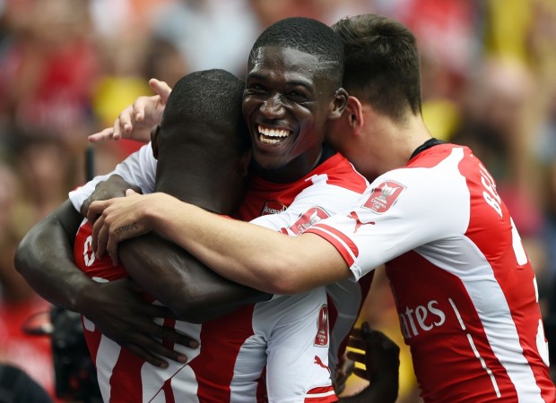Arsenal's Yaya Sanogo (C) and Hector Bellerin celebrate after Joel Campbell (L) scored against Benfica during the Emirates Cup match in London Arsenal vs Monaco